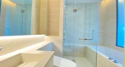 Modern bathroom with a large mirror and glass shower