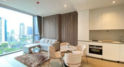 Modern living room with city view, white furniture and integrated kitchen