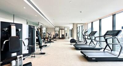 Modern gym with various exercise machines in a high-rise building