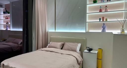 Modern bedroom with illuminated shelving and minimalistic decor