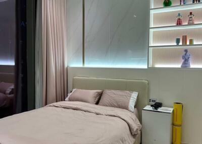 Modern bedroom with illuminated shelving and minimalistic decor