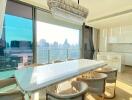 Modern kitchen and dining area with city skyline view through large windows
