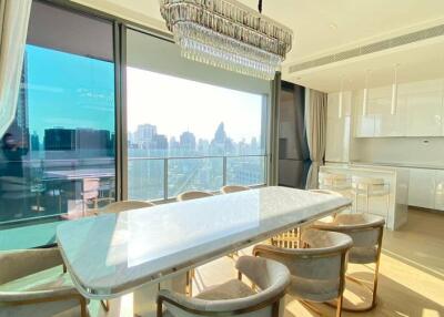Modern kitchen and dining area with city skyline view through large windows
