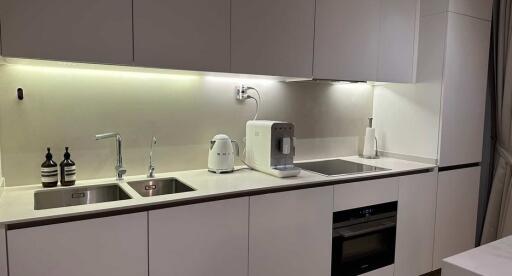 Modern kitchen with built-in appliances and LED lighting