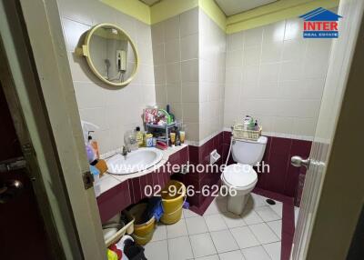 Compact bathroom with essential amenities and storage