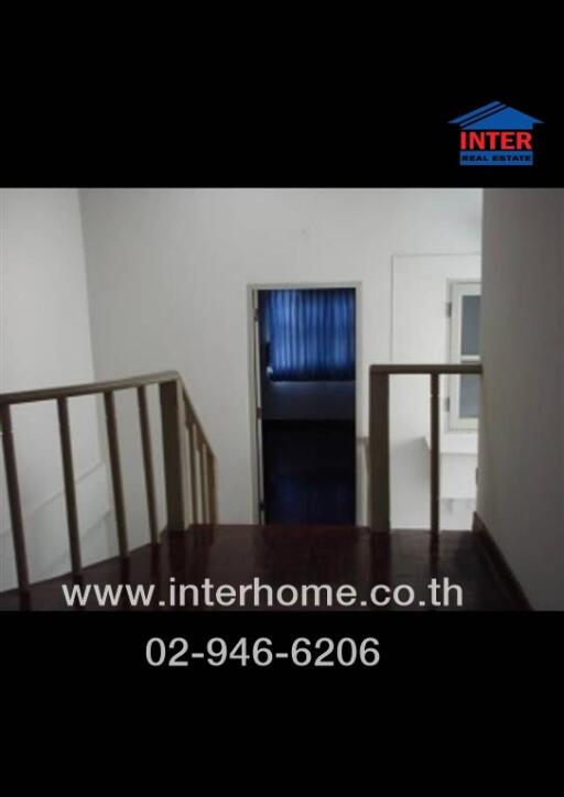 Interior hallway in a home with visible bedroom entrance