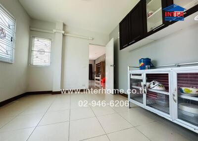Spacious and well-lit kitchen with modern appliances and ample storage
