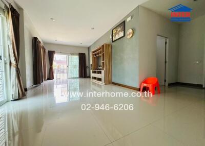 Spacious and bright living room with tiled flooring and large windows