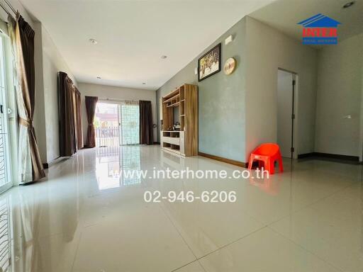 Spacious and bright living room with tiled flooring and large windows