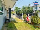 Cozy suburban house exterior with well-maintained garden and seating area