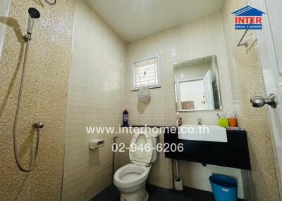 Modern bathroom with tiled walls and natural light