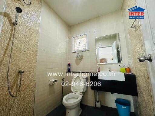 Modern bathroom with tiled walls and natural light