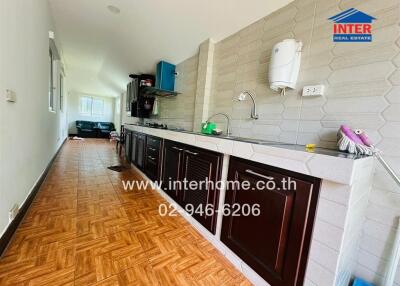 Spacious kitchen with modern amenities and wooden flooring