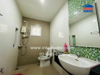 Modern bathroom with green mosaic tiles