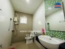 Modern bathroom with green mosaic tiles