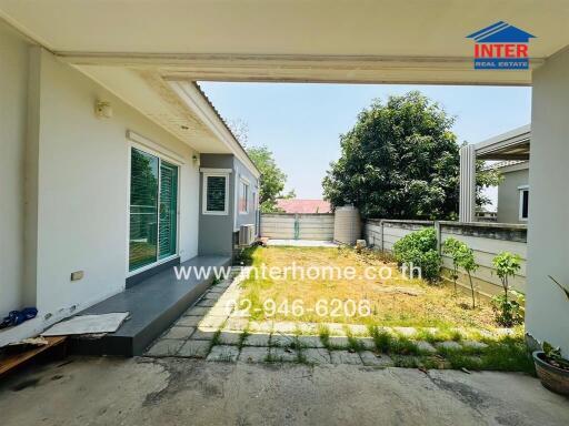 Spacious outdoor patio with covered area and sliding door access to the house