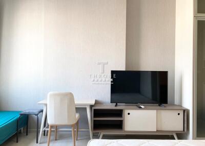 Modern minimalist living room with television and desk area