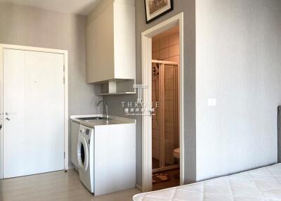 Compact bedroom with integrated laundry and kitchenette