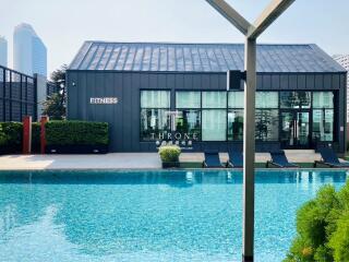 Modern fitness center adjacent to an outdoor swimming pool in an urban setting