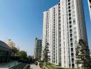 Modern high-rise residential building under clear blue sky