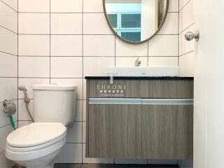 Modern bathroom with white tiles and wooden vanity