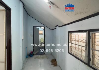 Bright and spacious hallway interior with large windows and blue walls