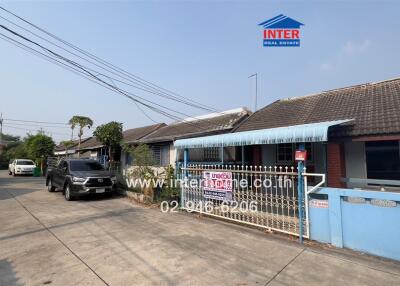 Exterior view of a residential property with gated entrance