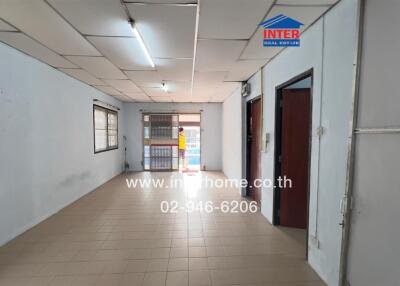 Spacious corridor in a commercial building with multiple doors and windows