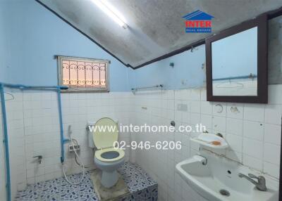 Spacious bathroom with skylight and blue tile flooring