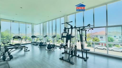 Spacious home gym with large windows and modern equipment