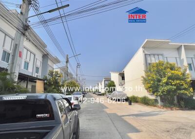 Residential street with modern houses and parked cars