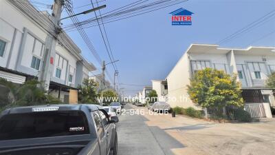 Residential street with modern houses and parked cars