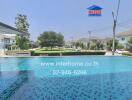 Luxurious outdoor swimming pool with surrounding residential housing