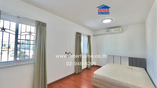 Spacious and well-lit bedroom with air conditioning