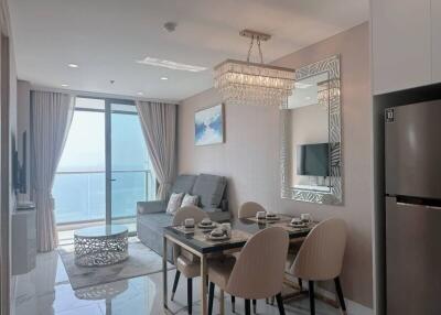 Modern living room with ocean view, elegant dining area, and stylish decor
