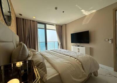 Modern bedroom with ample natural light and ocean view