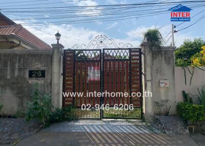 Exterior view of a residential property with a gated entrance