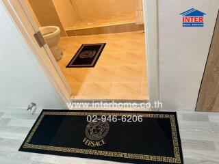 Modern bathroom interior with branded Versace floor mats