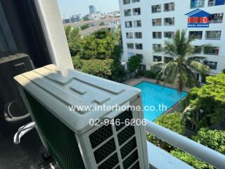 View from balcony showcasing air conditioning unit, swimming pool, and other buildings