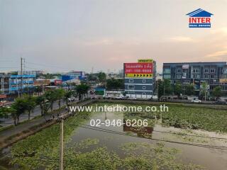 Aerial view of a residential area with waterbody and billboards