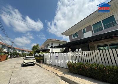 Modern residential street view of two-story homes under clear blue skies