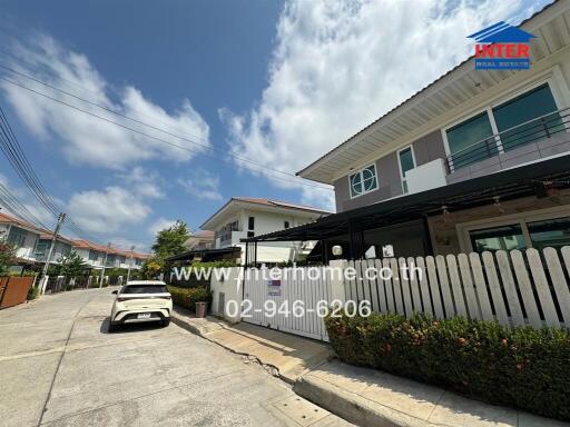 Modern residential street view of two-story homes under clear blue skies