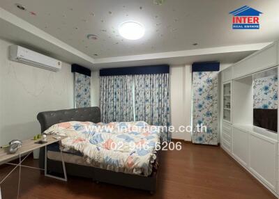 Modern bedroom with floral decor and ample lighting