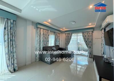 Elegant and spacious living room with modern decor featuring large windows and stylish furnishings