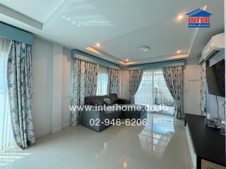 Elegant and spacious living room with modern decor featuring large windows and stylish furnishings