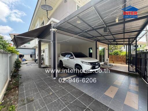 Spacious driveway with covered parking and tiled floor in modern home