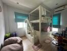 Spacious children's bedroom with bunk beds and ample natural light
