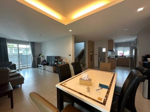 Spacious and contemporary living room with dining area and ambient lighting