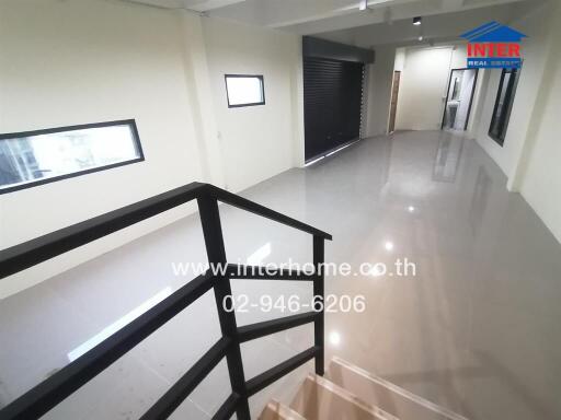 Spacious and modern interior hall with glossy tiled flooring and extensive lighting