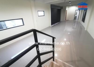 Spacious and modern interior hall with glossy tiled flooring and extensive lighting